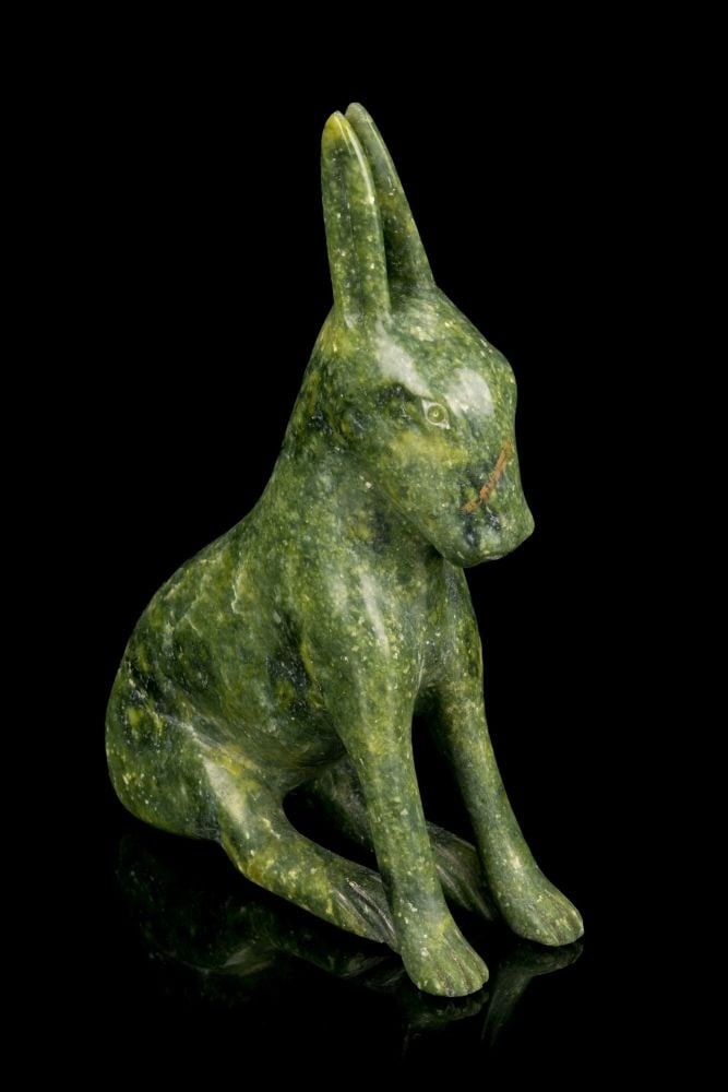 SHEOKJUK OQUTAQ, INUIT, Seated Arctic Hare,: SHEOKJUK OQUTAQ (1920-1982) KINNGAIT (CAPE DORSET) Seated Arctic Hare, stone, 8.5 x 6.25 x 2.25 in (21.6 x 15.9 x 5.7 cm) signed, "ᓯᐅᔪ". Provenance Collection of John and Joyce Price