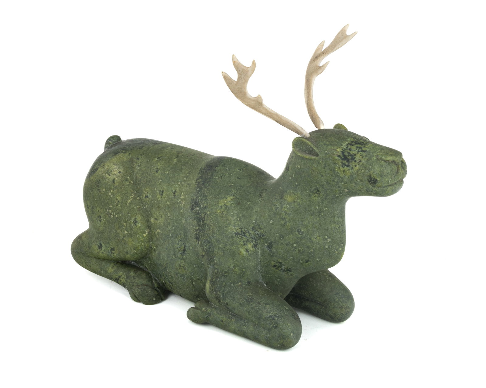 Poss: KIAWAK ASHOONA, INUIT, Kneeling Caribou, 1960s: Possibly: KIUGAK (KIAWAK) ASHOONA, O.C., R.C.A. (1933-2014) KINNGAIT (CAPE DORSET) Kneeling Caribou, 1960s stone and antler, 8.25 x 10.5 x 3.25 in (21 x 26.7 x 8.3 cm) unsigned. Provenance Collection 