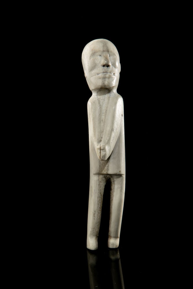 JACOB ITKELIK, INUIT, Standing Man with Clasped Hands, mid 1960s: JACOB ITKELIK (1923-D) QAMANI'TUAQ (BAKER LAKE) Standing Man with Clasped Hands, mid 1960s antler, 7.5 x 1.25 x 2.25 in (19.1 x 3.2 x 5.7 cm) unsigned. Provenance Collection of Vivian Julien, a school
