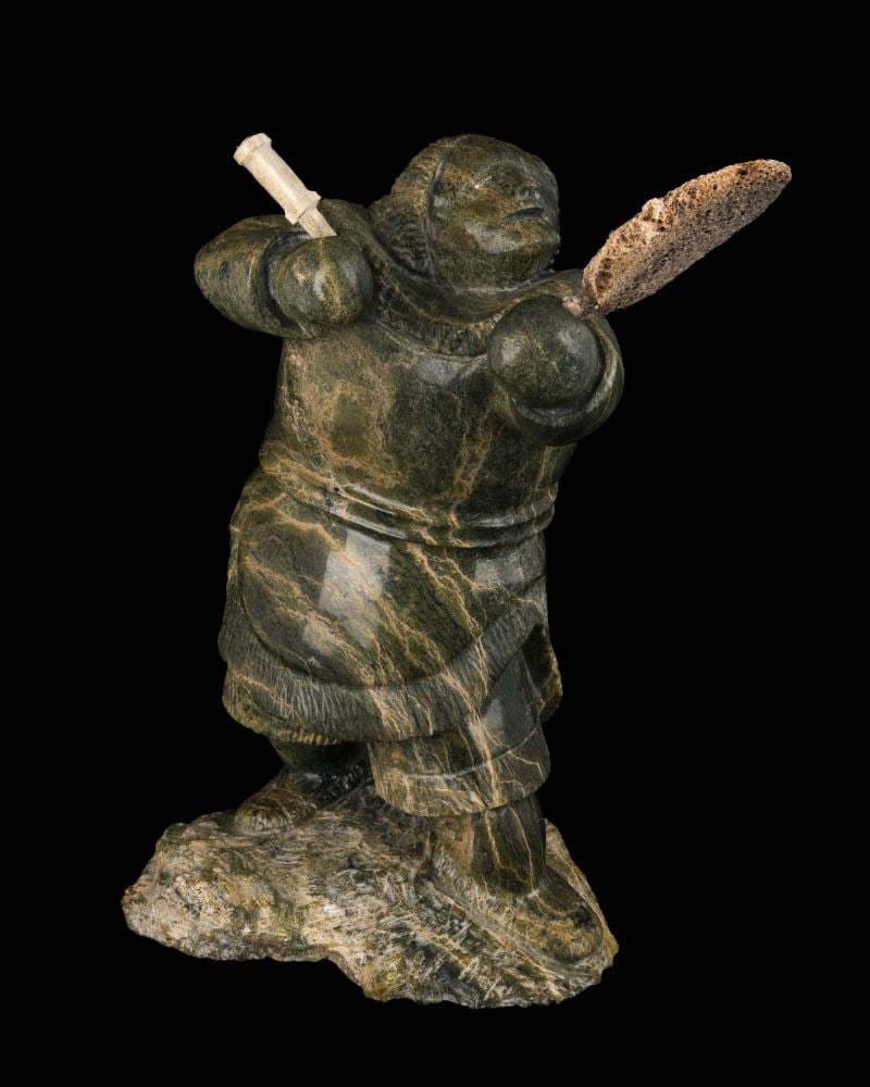 JACO ISHULUTAQ, INUIT, Drum Dancer, 1990s: JACO ISHULUTAQ (1951-) PANNIRTUQ (PANGNIRTUNG) Drum Dancer, 1990s stone, bone, and antler, 18.5 x 10 x 9 in (47 x 25.4 x 22.9 cm) signed, "ᔪᑯ ᐃᓱᓚᑕ". Provenance Priv