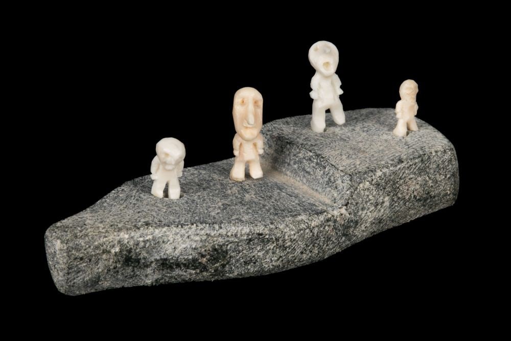 MARK TUNGILIK, INUIT, Quartet of Singing Men, Two With Large Noses, 1970s: MARK TUNGILIK (1913-1986) NAUJAAT (REPULSE BAY) Quartet of Singing Men, Two With Large Noses, 1970s stone and walrus tusk, 1.25 x 3.5 x 1.5 in (3.2 x 8.9 x 3.8 cm) signed, "ᒪ. ᑐᒋ5