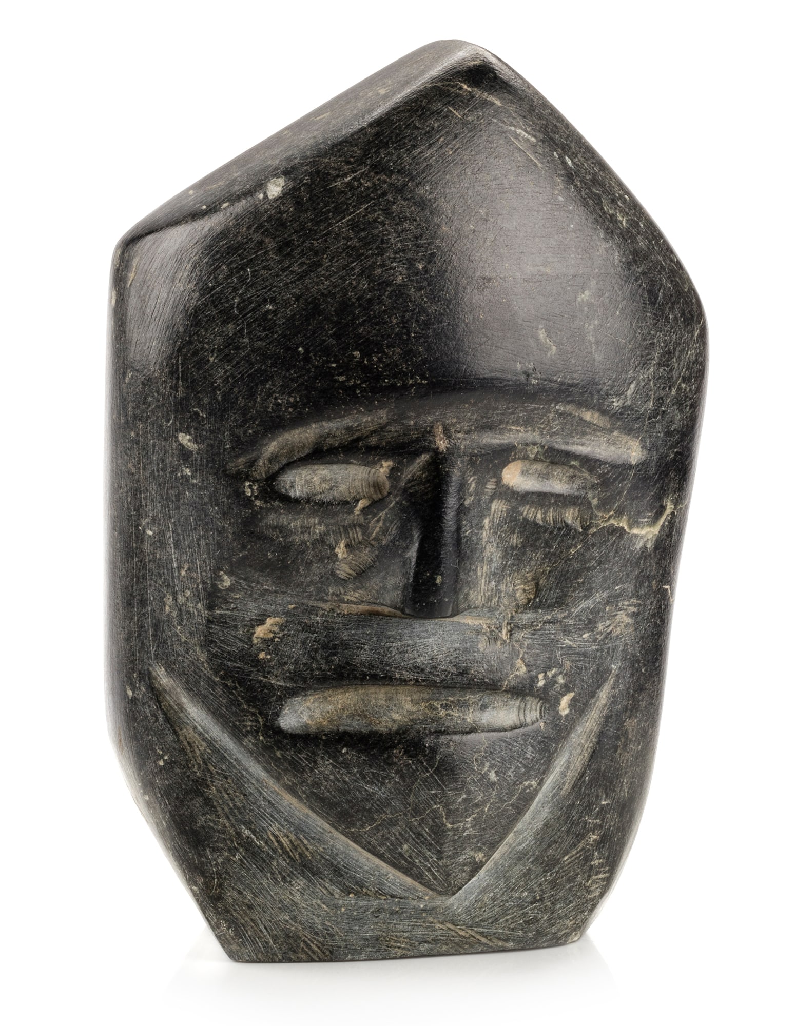 JOHN KAVIK, INUIT, Hooded Face, early to mid 1970s: JOHN KAVIK (1897-1993) KANGIQLINIQ (RANKIN INLET) Hooded Face, early to mid 1970s stone, 6.25 x 4 x 2.75 in (15.9 x 10.2 x 7 cm) signed, "ᑲᕕ". Provenance An Ottawa Collection. Kavik and hi