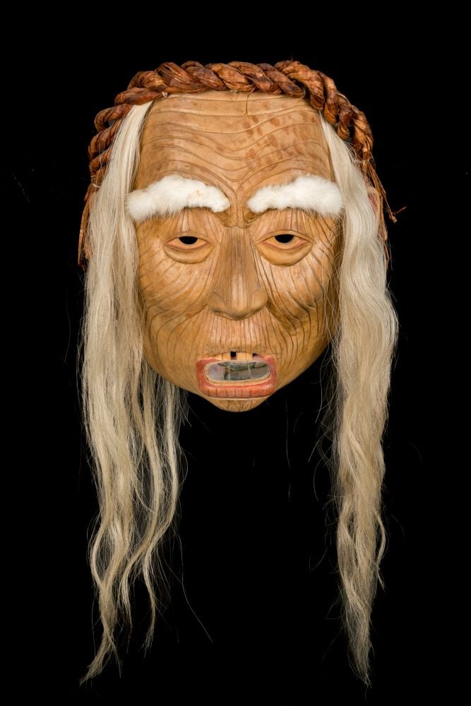 GLEN RABENA, NON-INDIGENOUS, ADOPTED HAIDA, Old Woman with Labret Mask, 2007: GLEN RABENA (1953-), NON-INDIGENOUS, ADOPTED HAIDA, HORNBY ISLAND Old Woman with Labret Mask, 2007 alder wood, fur, hair, hammered cedar bark, abalone, copper, resin beads, and rope, 12 x 9 x 5 in. (3