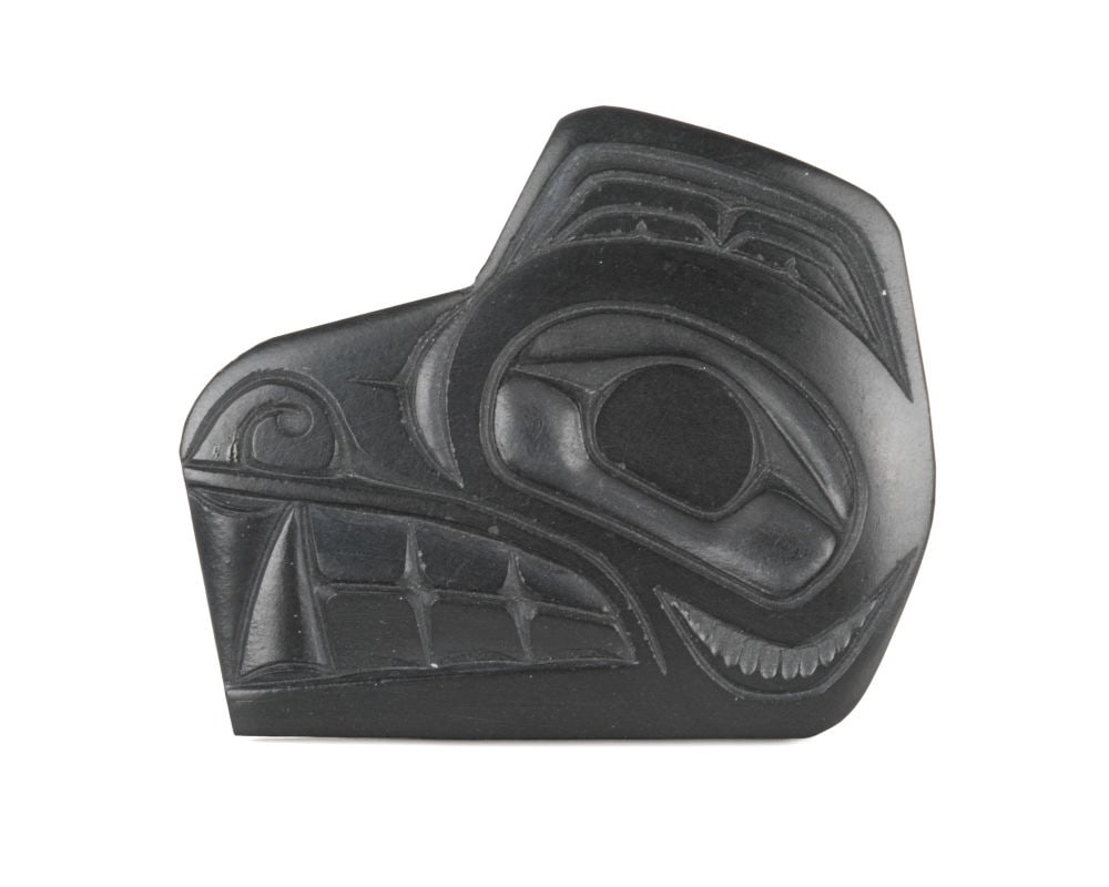 PAT DIXON, HAIDA, Wolf Head Brooch, late 1980s: PAT DIXON (1938-2015) HAIDA Wolf Head Brooch, late 1980s argillite, 1.5 x 2 x 0.125 in (3.8 x 5.1 x 0.3 cm) signed, "PAT DIXON". Provenance Private Collection, Toronto. Pat Dixon, from Skidegate in H