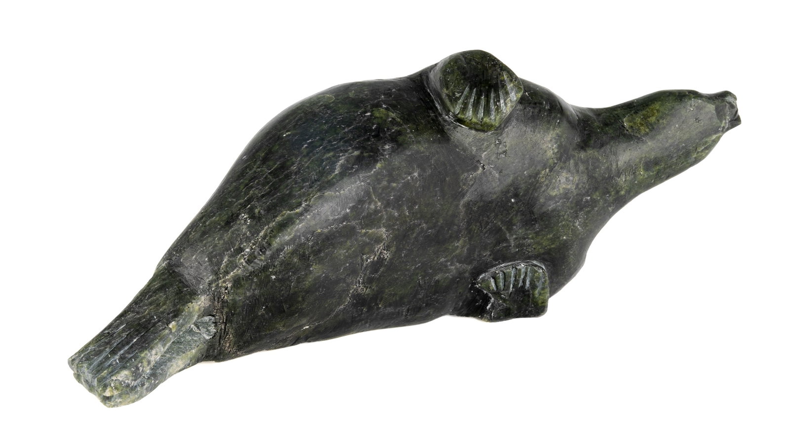 Probably SIMIGAK SIMEONIE, INUIT, Lounging Seal, 1962: Probably SIMIGAK SIMEONIE (1939-2004) KINNGAIT (CAPE DORSET) Lounging Seal, 1962 stone, 3.75 x 11 x 3.75 in (9.5 x 27.9 x 9.5 cm) with affixed label from La Guilde (The Canadian Handicrafts Guild), in