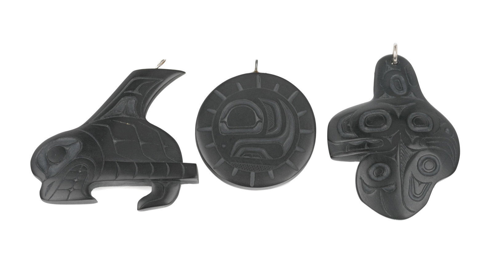 CALVIN BELL, RICHARD SILAS, & PAT DIXON, Three Pendants, c. 2000s / Jan 1974 / Oct 2002: CALVIN BELL (1950-), HAIDA, MASSET / RICHARD SILAS YELTATZIE (1955-1974) HAIDA / PAT DIXON (1938-2015) HAIDA Three Pendants, c. 2000s / Jan 1974 / Oct 2002 each argillite, the first a killer whale by 