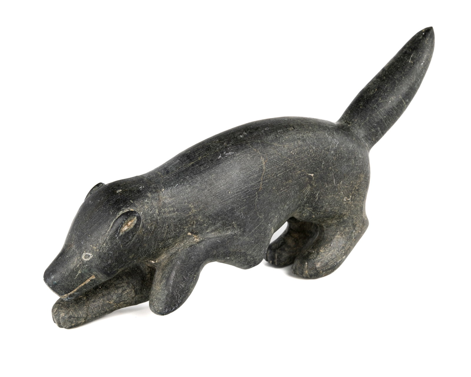 WEETALTUK, KUUJJUARAPIK, INUIT, Dog, Low and Advancing, 1959: WEETALTUK, KUUJJUARAPIK (GREAT WHALE RIVER) or INUKJUAK (PORT HARRISON) Dog, Low and Advancing, 1959 stone, 4 x 8 x 1.75 in (10.2 x 20.3 x 4.4 cm) unsigned; with affixed label from La Guilde (The Cana