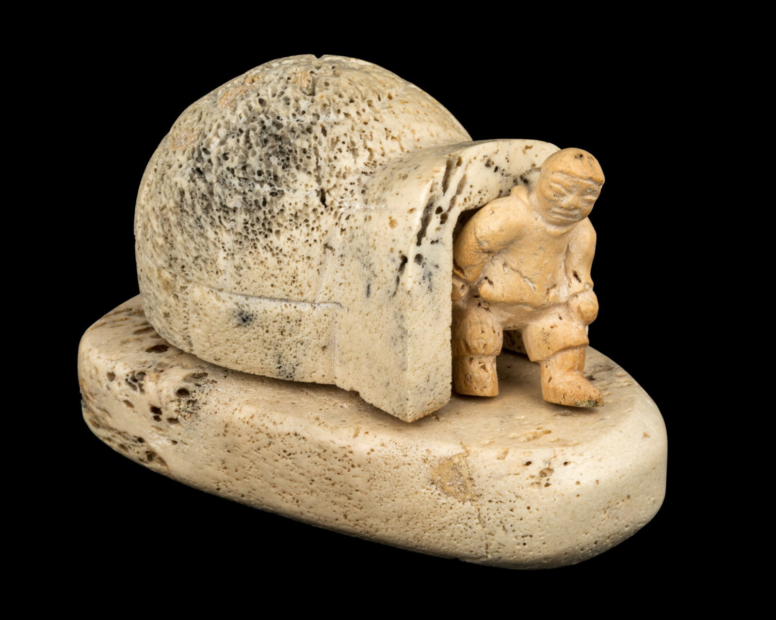 Probably IRENE KATAQ ANGUTITOK, INUIT, Man Exiting a Snowhouse, 1961: Probably IRENE KATAQ ANGUTITOK (1914-1971) NAUJAAT (REPULSE BAY) Man Exiting a Snowhouse, 1961 whale bone and antler, 3.75 x 6 x 4 in (9.5 x 15.2 x 10.2 cm) with affixed label from La Guilde (The Cana