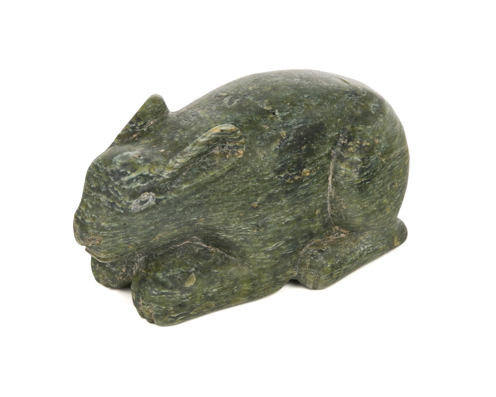 KANANGINAK POOTOOGOOK, INUIT, Crouched Arctic Hare, 1958: KANANGINAK POOTOOGOOK, R.C.A. (1935-2010) KINNGAIT (CAPE DORSET) Crouched Arctic Hare, 1958 stone, 1.5 x 4.5 x 2 in (3.8 x 11.4 x 5.1 cm) unsigned; with affixed label from La Guilde (The Canadian Hand