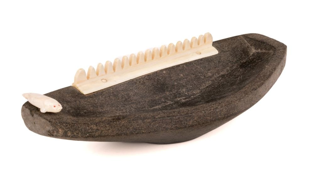 UNIDENTIFIED INUIT ARTIST, EASTERN CANADIAN ARCTIC, Model Qulliq with Decorative Seal, c. 1955: UNIDENTIFIED INUIT ARTIST, EASTERN CANADIAN ARCTIC Model Qulliq with Decorative Seal, c. 1955 stone, organic material (see firstarts.ca for details), and red inlay, 2.25 x 10 x 4.5 in (5.7 x 25.4 x 11