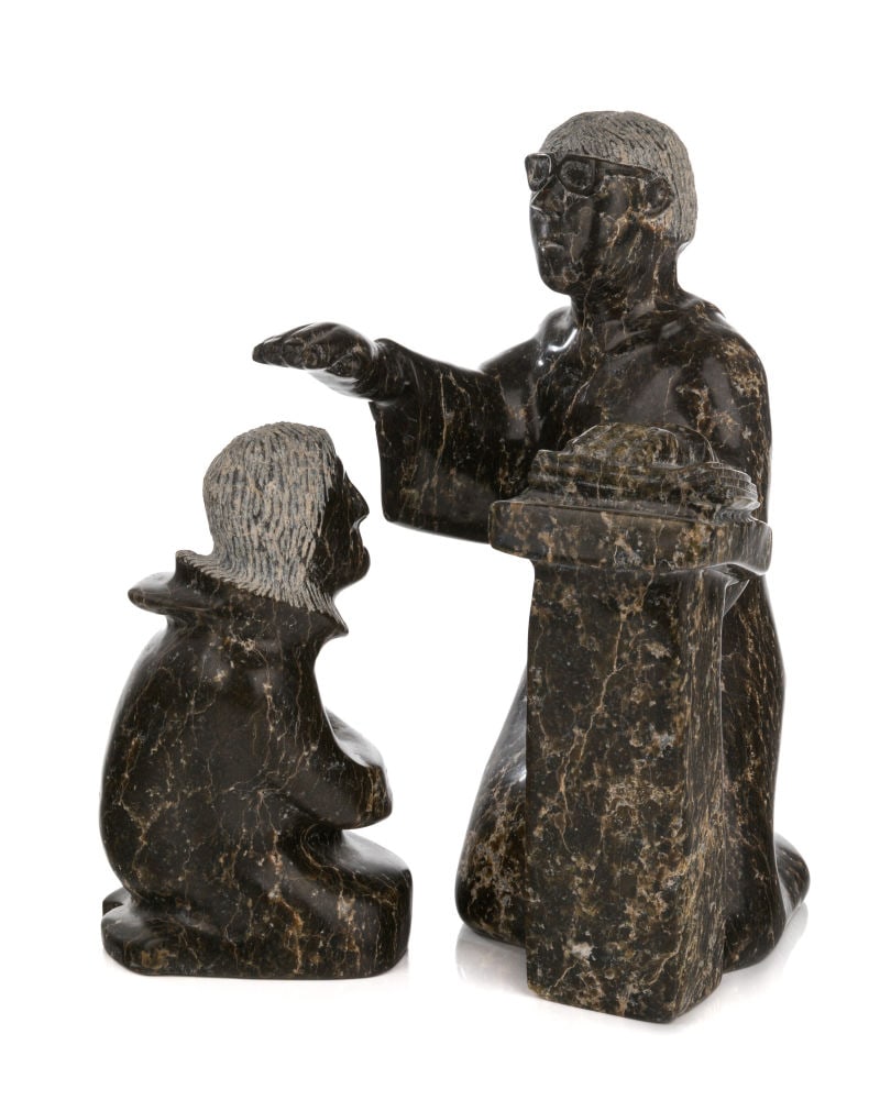 ADAMIE ASHEVAK, INUIT, Priest Blessing Parishioner, 1990s / 2000s: ADAMIE ASHEVAK (1959-) KINNGAIT (CAPE DORSET) Priest Blessing Parishioner, 1990s / 2000s stone and black, dimensions variable, the priest: 13.5 x 8 x 8.25 in (34.3 x 20.3 x 21 cm) / the parishioner: 9