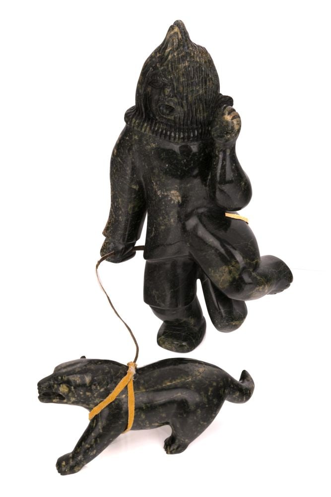 PALAYA QIATSUK, INUIT, Shaman with Sled Dog, 1990s: PALAYA QIATSUK (1965-) KINNGAIT (CAPE DORSET) Shaman with Sled Dog, 1990s stone and skin, dimensions variable, shaman: 13.5 x 8.25 x 3 in (34.3 x 21 x 7.6 cm) / sled dog, 3.25 x 8.5 x 2.5 in (8.3 x 21