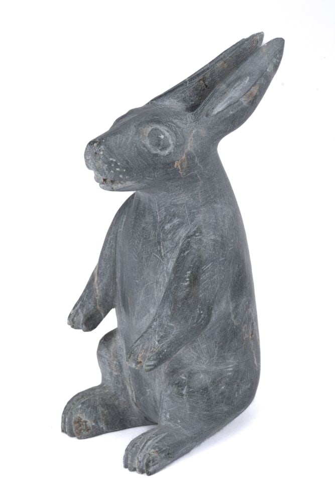 JOE TALIRUNILI, INUIT, Alert Arctic Hare, c. 1970: JOE TALIRUNILI (1893-1976) PUVIRNITUQ (POVUNGNITUK) Alert Arctic Hare, c. 1970 stone, 4.75 x 2.5 x 1.75 (12.1 x 6.3 x 4.4 cm) signed, "JOE". Provenance Collection of a prominent Montreal businessman, 