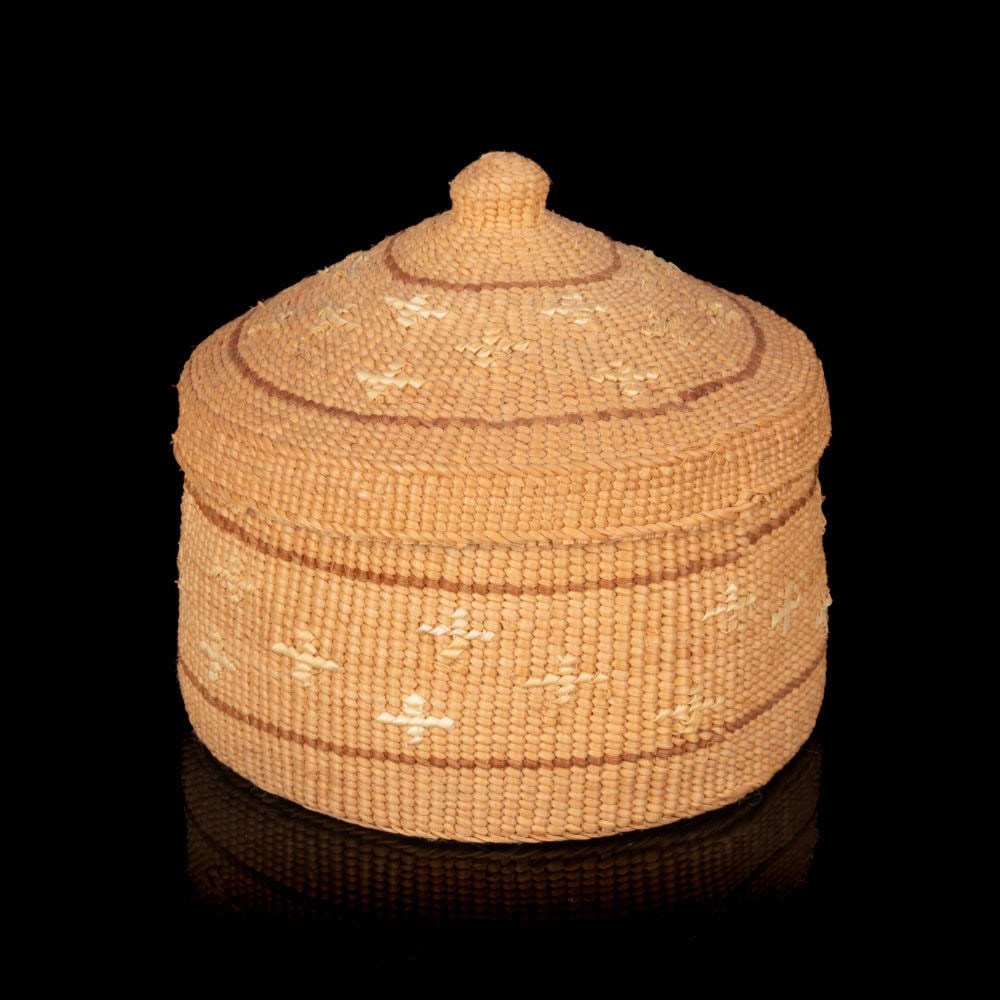 ISABEL RORICK, HAIDA, Winter Solstice (Snowflake Design Rattle Top Basket), c. 2011: ISABEL RORICK (1955-) HAIDA, OLD MASSET, HAIDA GWAIIWinter Solstice (Snowflake Design Rattle Top Basket) c. 2011 root, sun bleached sweet grass stems, alder dyed spruce root, 2.5 x 2.75 x 2.75 in (6.3