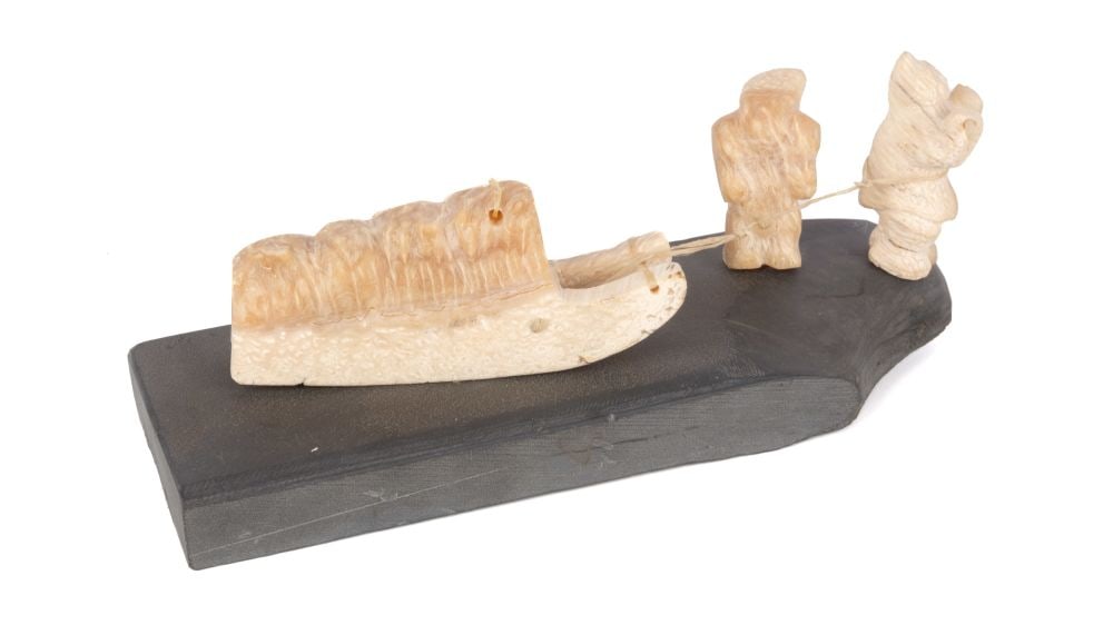 BARNABUS ARNASUNGAAQ, INUIT, Figures Preparing a Qamutiik (Komatik), c. early 1970s: BARNABUS ARNASUNGAAQ (1924-2017) QAMANI'TUAQ (BAKER LAKE) Figures Preparing a Qamutiik (Komatik) c. early 1970s muskox horn and stone, 2.75 x 8.75 x 3.25 in (7 x 22.2 x 8.3 cm) unsigned. ESTIMATE: $60