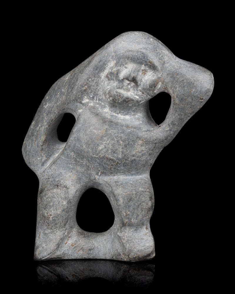 JOHN KAVIK, INUIT, Figure with Spread Legs and Hands on Head, 1970s: JOHN KAVIK (1897-1993) KANGIQLINIQ (RANKIN INLET) Figure with Spread Legs and Hands on Head, 1970s stone, 9 x 8 x 3 in (22.9 x 20.3 x 7.6 cm) signed, “ᑲᕕ”. ESTIMATE: $2,500 — $3,