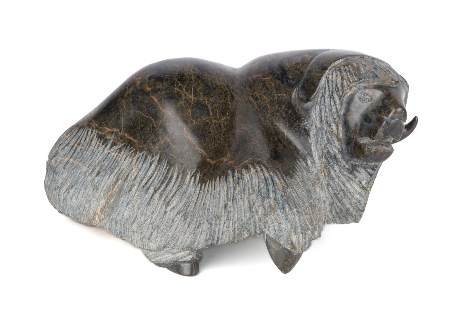 QIATSUQ SHAA, INUIT, Muskox Gathering Itself to Rear, 1990s: QIATSUQ SHAA (1971-1998) KINNGAIT (CAPE DORSET) Muskox Gathering Itself to Rear, 1990s stone, 6.25 x 10 x 12.5 in (15.9 x 25.4 x 31.8 cm) signed, "ᑭᐊᓱ . ᓴ". ESTIMATE: $700 —