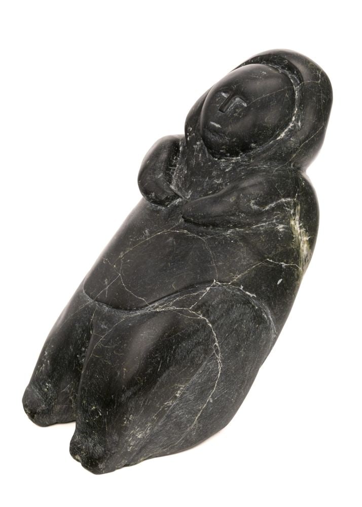 EMMA NATAKOK, INUIT, Leaning Woman, 1981: EMMA NATAKOK (1915-D) SALLIT (CORAL HARBOUR) Leaning Woman, 1981 stone, 12 x 7 x 9.5 in (30.5 x 17.8 x 24.1 cm) unsigned; given to the artist and dated to the affixed sticker. ESTIMATE: $500 — $800
