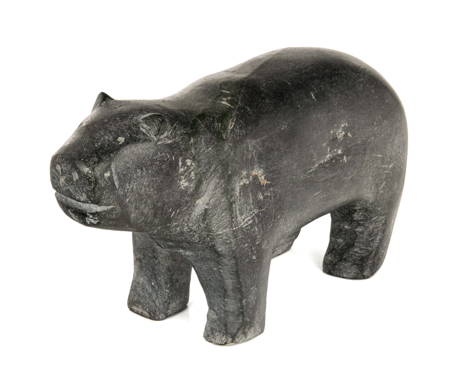 MARK TUNGILIK, INUIT, Bear, late 1970s: MARK TUNGILIK (1913-1986) NAUJAAT (REPULSE BAY) Bear, late 1970s stone, 5.5 x 9.75 x 3.75 in (14 x 24.8 x 9.5 cm) signed and inscribed, "ᒪ. ᑐᒋᓕ / ᓇᐅᔭ [Naujaat