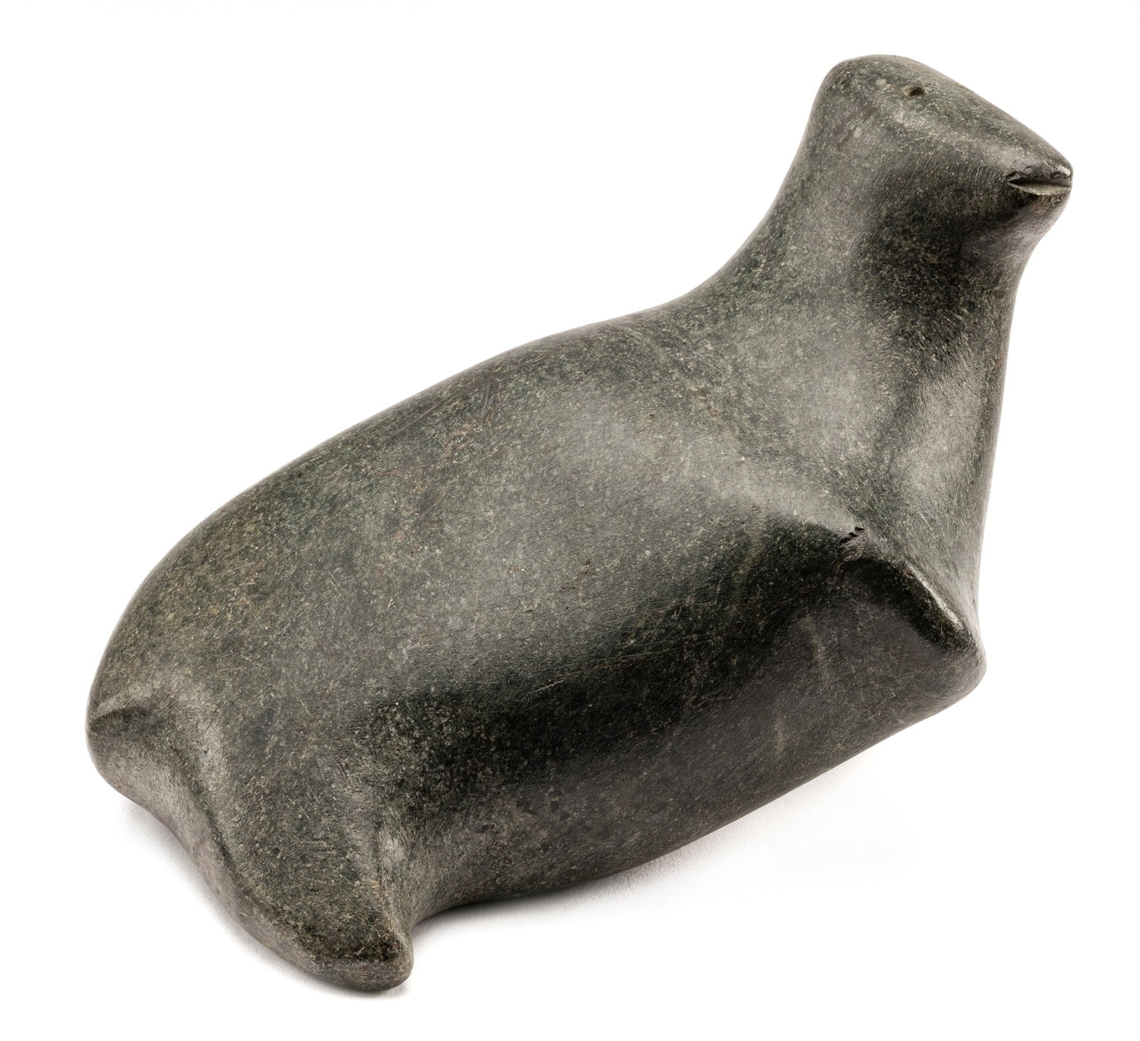 ANDY MIKI, INUIT, Resting Animal, c. 1965-68: ANDY MIKI (1918-1983) ARVIAT/TIKIRAQJUAQ (ESKIMO POINT/WHALE COVE) Resting Animal, c. 1965-68 stone, 4.25 x 6.5 x 4.5 in (10.8 x 16.5 x 11.4 cm) signed, "ᒥᑭ". Provenance A British Columbia