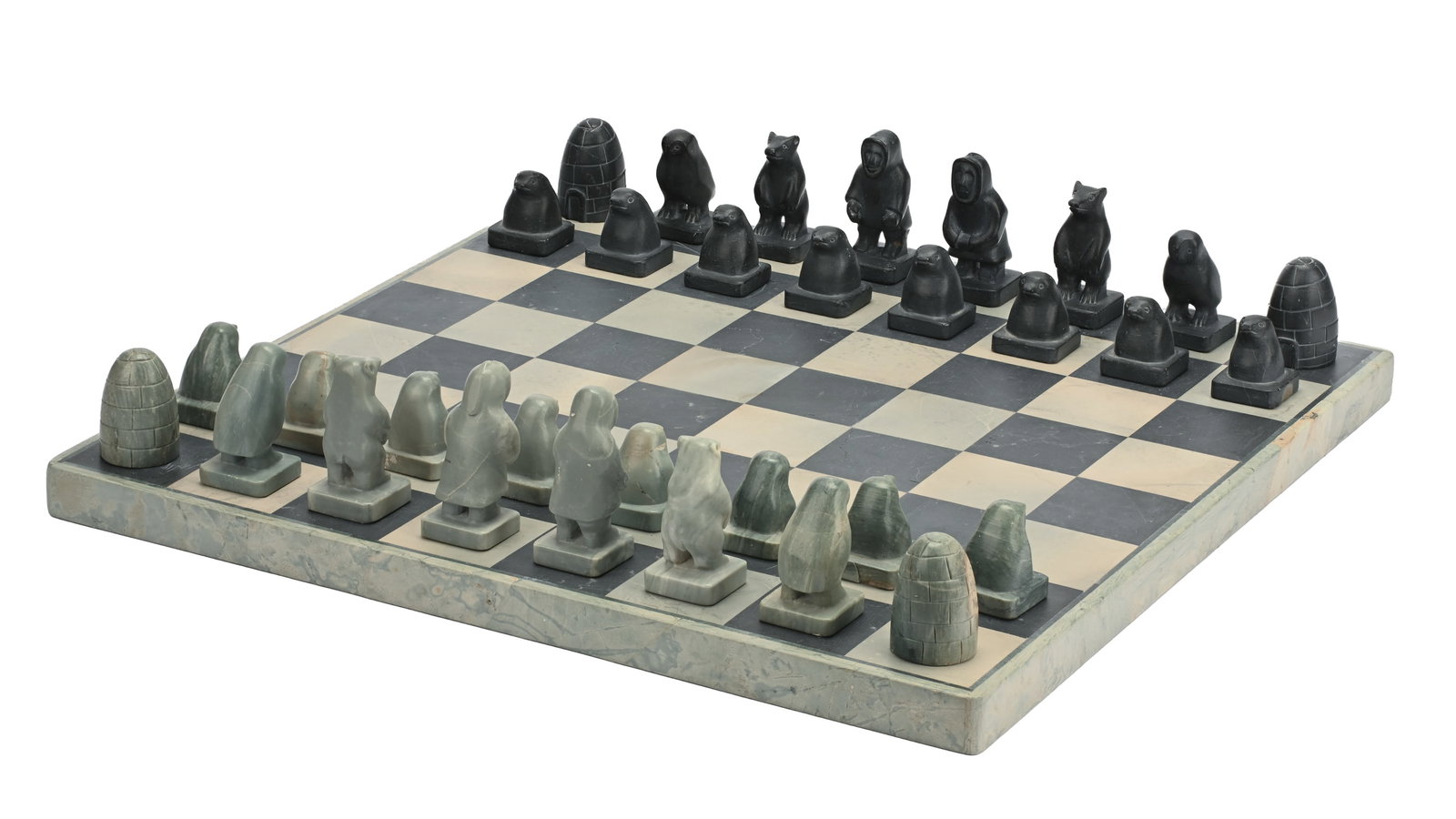 MOSES PANIDJUK, INUIT, Chess Set, c. 1977: MOSES PANIDJUK (1928-D) QINGAUT (BATHURST INLET) Chess Set, c. 1977 stone, the board: 16.25 x 16.25 x 1 in (41.3 x 41.3 x 2.5 cm) / the largest game piece (King): 2.75 x 1.25 x 1.25 in (7 x 3.2 x 3.2 