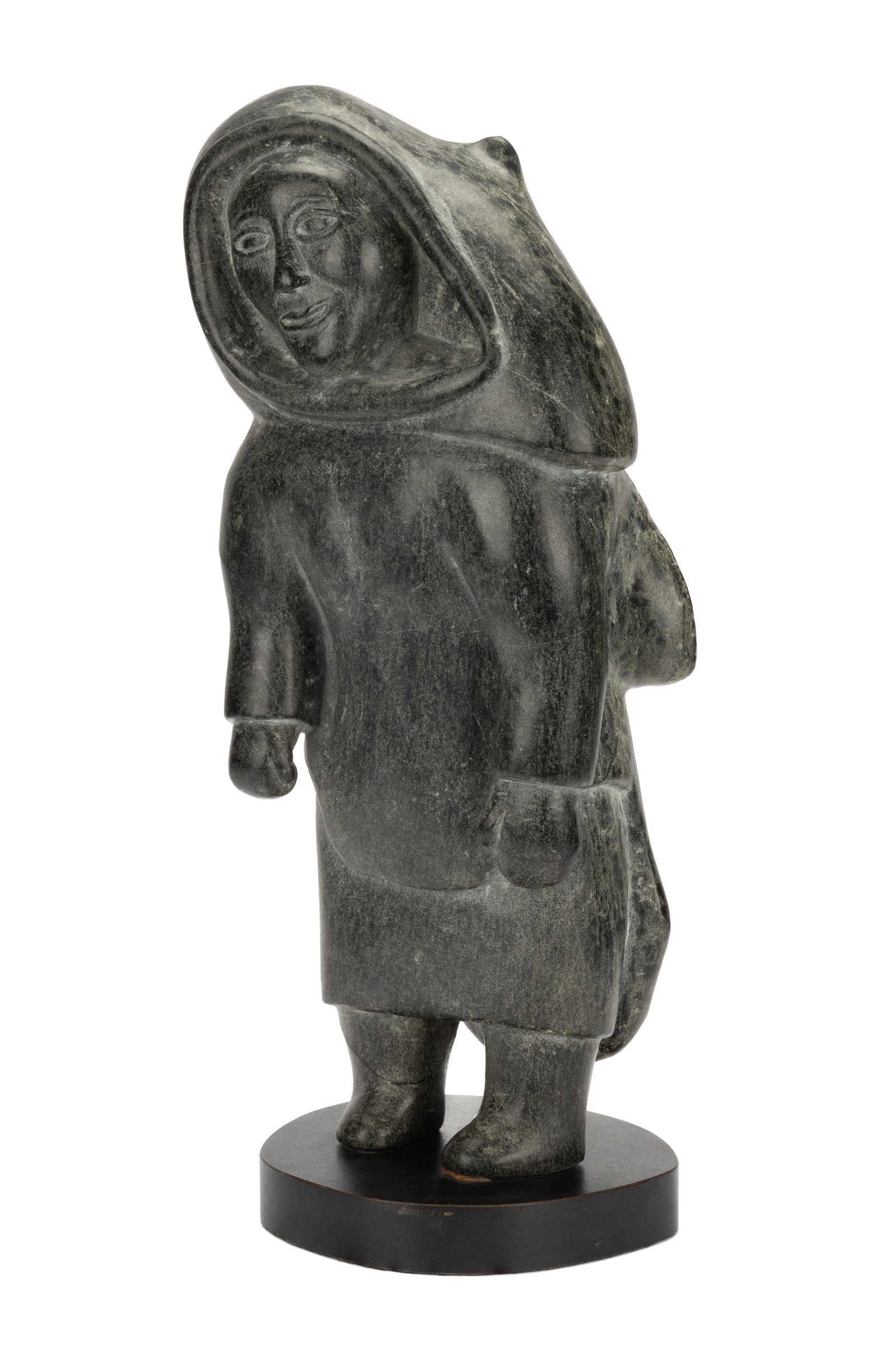 AUDLA PEE, INUIT, Smiling Woman, c. 1975: AUDLA PEE (1920-2002) KINNGAIT (CAPE DORSET) Smiling Woman, c. 1975 stone, 23.5 x 10.25 x 7.5 in (59.7 x 26 x 19.1 cm) unsigned; given to the artist to an affixed sticker, in blue ink, in an unknown h