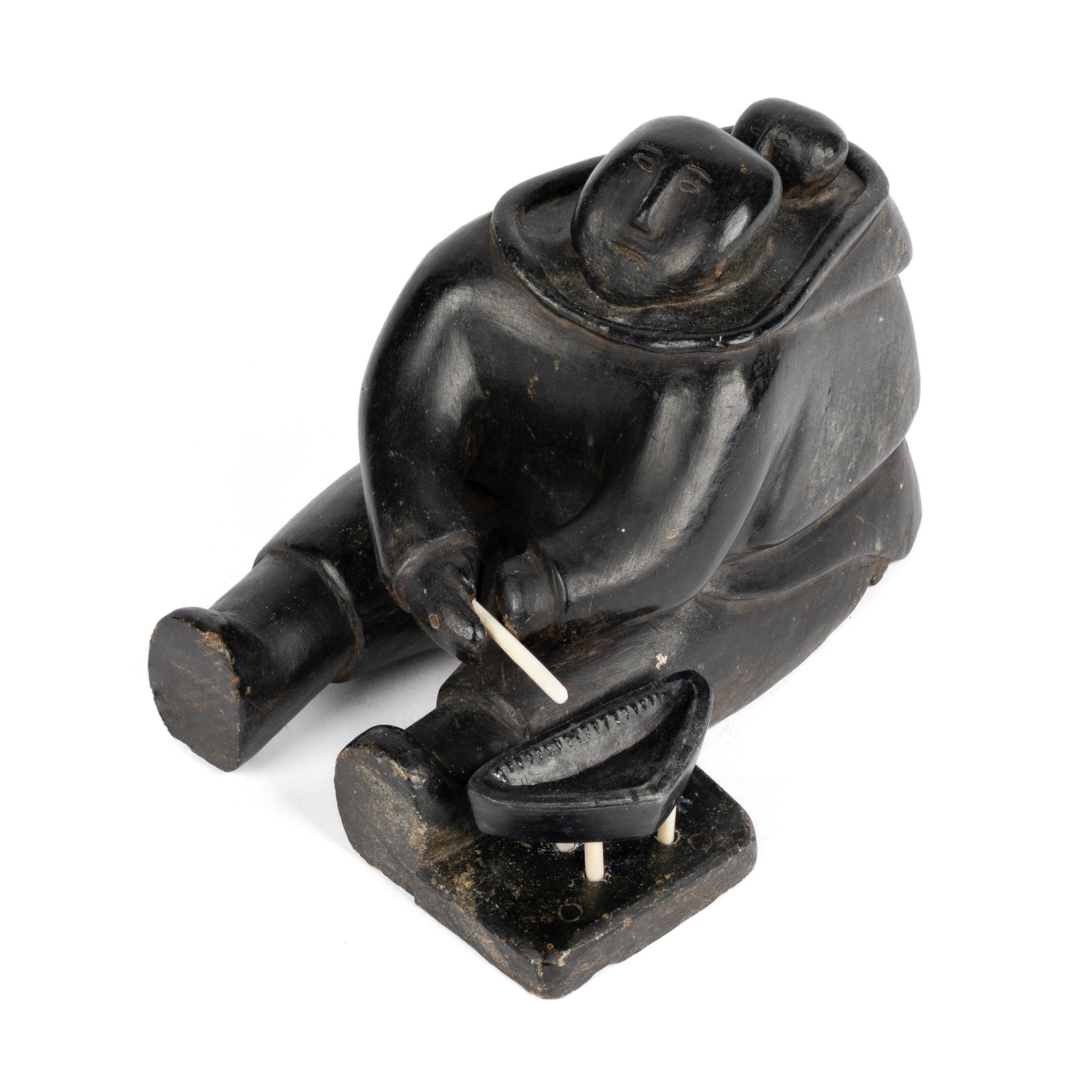 UNIDENTIFIED INUIT ARTIST, Seated Woman, with Child in Amautiq Tending a Qulliq (Kudlik), early-mid: UNIDENTIFIED INUIT ARTIST, NUNAVIK (ARCTIC QUEBEC) Seated Woman, with Child in Amautiq Tending a Qulliq (Kudlik), early-mid 1950s stone and antler, 4.5 x 5 x 7 in (11.4 x 12.7 x 17.8 cm) signed indist