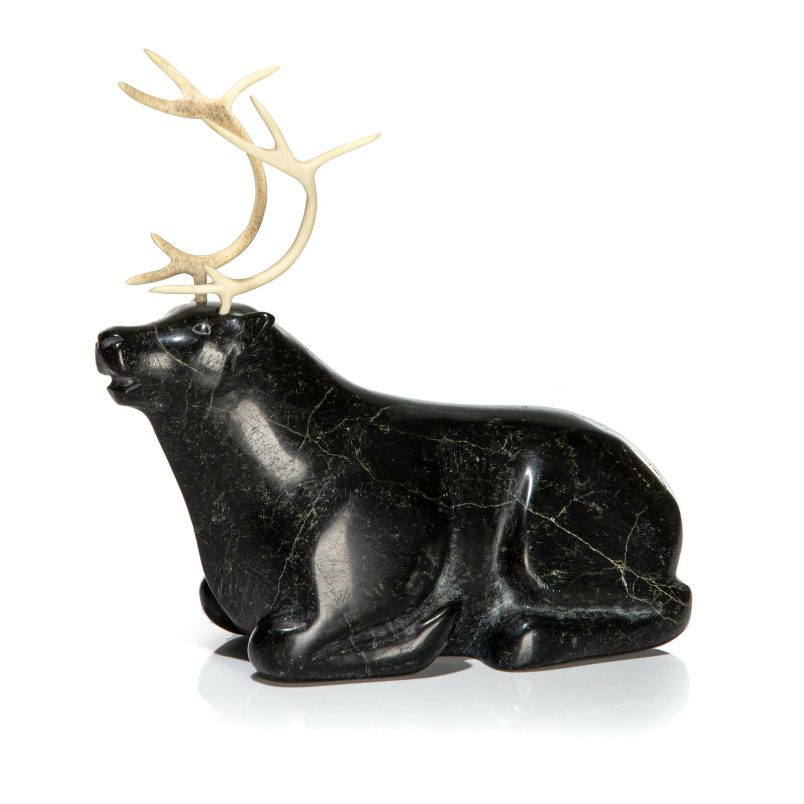 JAYBEDDIE AMAGOALIK, INUIT, Resting Caribou, 1980s: JAYBEDDIE AMAGOALIK, QAUSUITTUQ (RESOLUTE BAY) Resting Caribou, 1980s stone and antler, 7.75 x 8.25 x 4 in (19.7 x 21 x 10.2 cm) signed, "Jaybeddie / Amagoalik". Provenance Purchased in the mid-1960s-