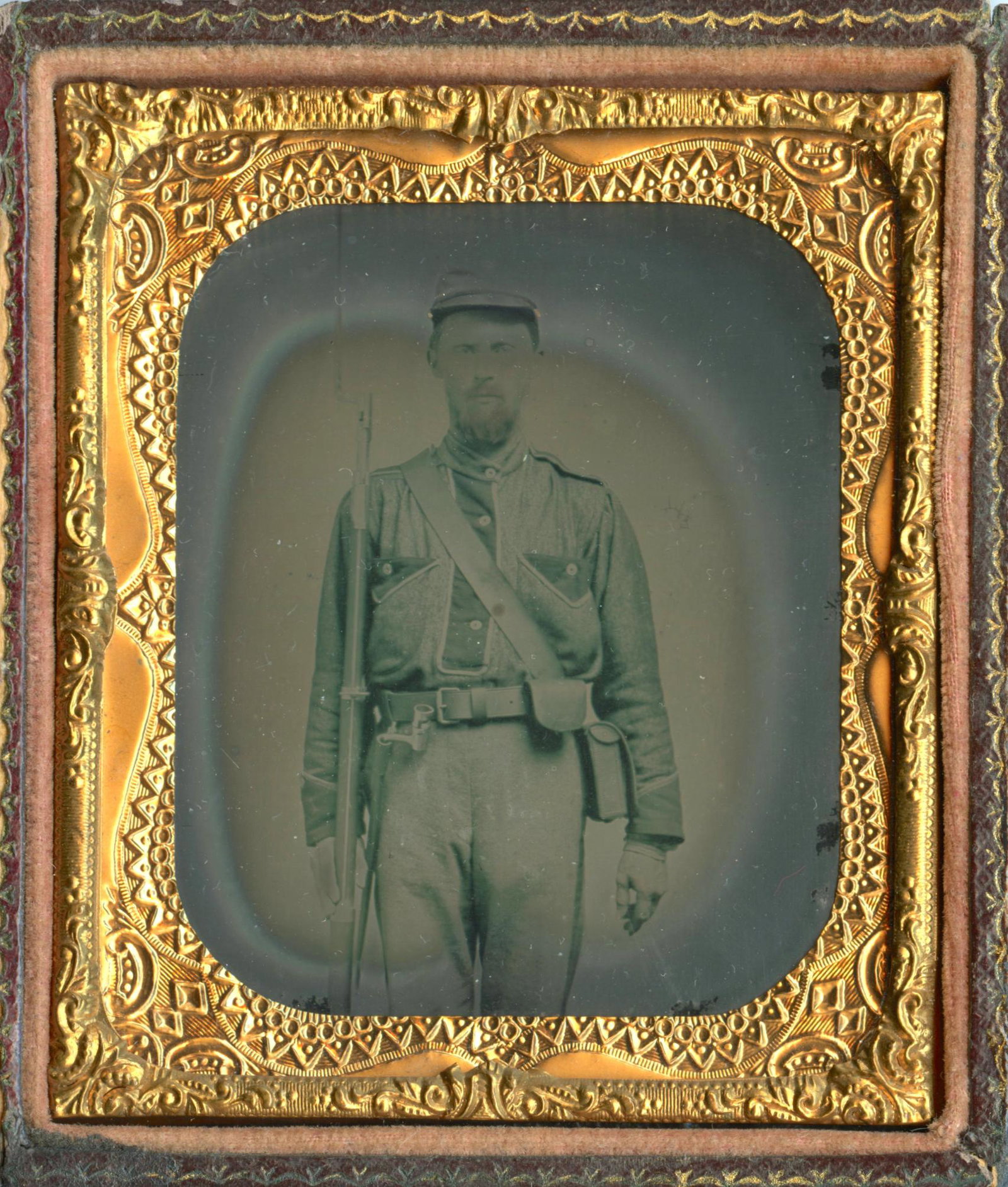 Confederate Ambrotype- “Battleshirt”: Sixth plate ambrotype of an armed Confederate soldier wearing a “battleshirt,” similar to others known to be worn in Texas and the Western Theatre of the war. Some solarizaion, housed in a full le