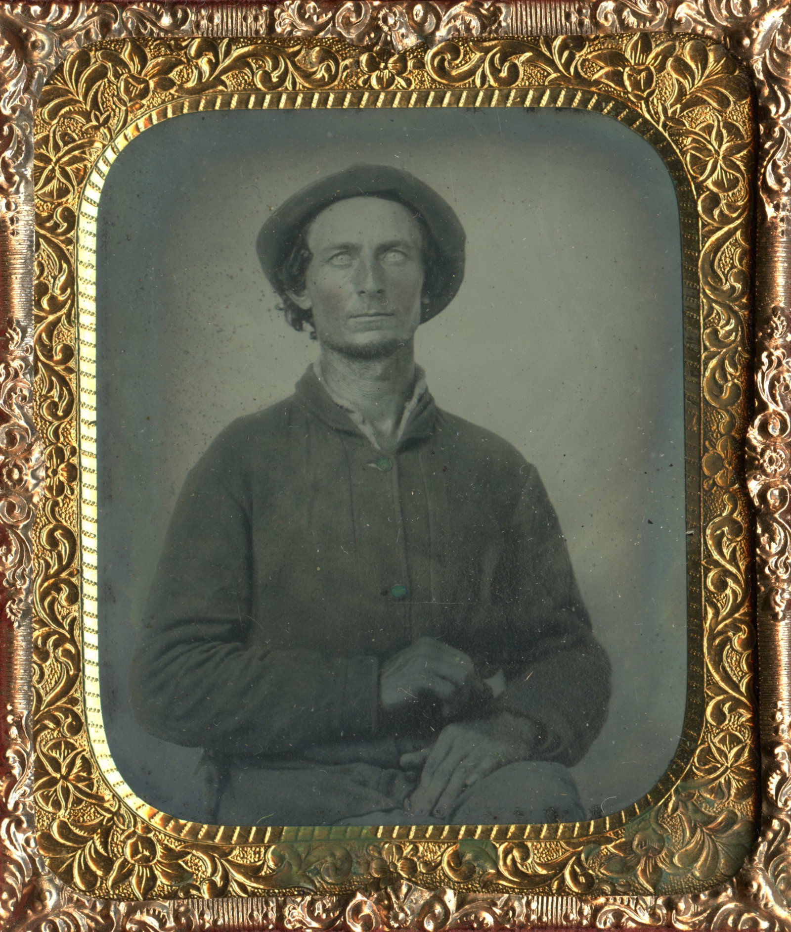 Fine Portrait of a Solder: This engaging sixth-plate tintype features a seated Union soldier who looks very suave. Dressed in a standard sack coat, he wears his hat at a jaunty angle and casts a confident expression to the came