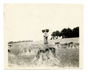 Adorable Photo of a Child on Haystack: ca. 1920s-1940s. [Early Photography] [Contemporary Photography] [Americana]