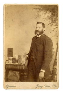 Superb Cabinet Card Photograph [Early Advertising]: Superb cabinet card photograph of a man showing off canned products he ostensibly produced. The upturned notebook has the impressed name "Jno. H. Condo" and one of the cans reads "Condo's Favorites,"