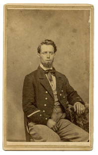 CDV of Civil War Soldier- Glass Eye?: Carte-de-visite (CDV) of a seated Civil War soldier who appears to have a glass eye, perhaps a battle wound. The "veteran" stripe near his cuffs indicates he had served at least one enlistment period