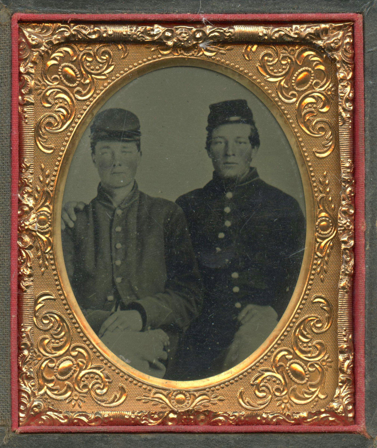Two Soldiers Seated Together [Civil War] [Tintype]: Sixth plate tintype of two affectionate Civil War soldiers housed in a full leatherette case. [Civil War, Union, Confederate, Daguerreotype, carte-de-visite, CDV, ambrotype, tintype, Robert E. Lee,]