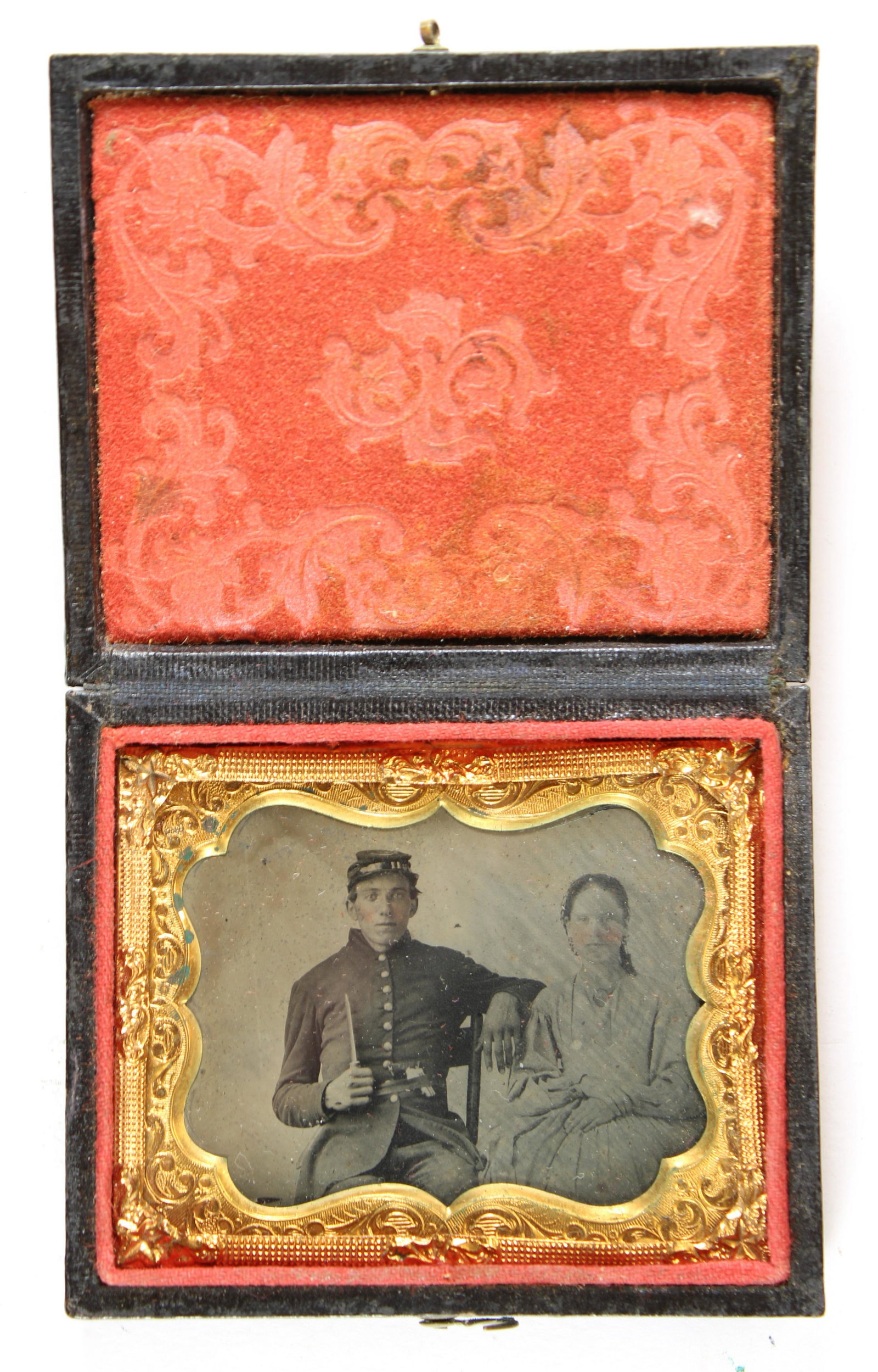 Soldier w/ Knife & Wife [Civil War] [Tintype]: Ninth plate tintype of a Civil War soldier armed with a knife seated next to his wife. Housed in a full leatherette case. [Civil War, Union, Confederate, Daguerreotype, carte-de-visite, CDV, ambrotype