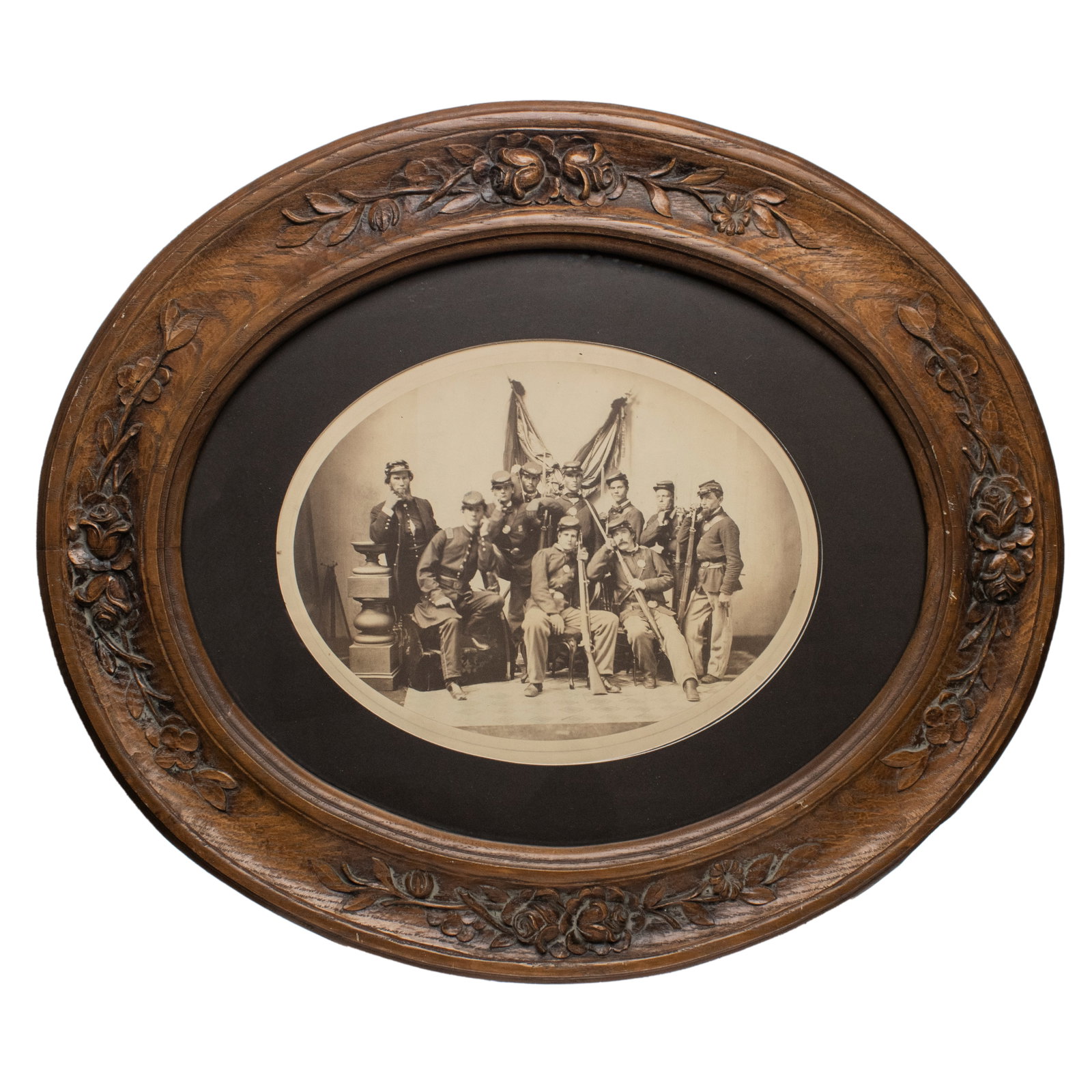 [CIVIL WAR] Guard of Honor for a Fallen General: Spectacular Identified 10th Ohio Infantry Albumen: A large-format oval albumen photograph housed in an elaborately carved period wooden frame with floral motifs. The image depicts ten members of the 10th Ohio Volunteer Infantry, posed as a Guard of Ho