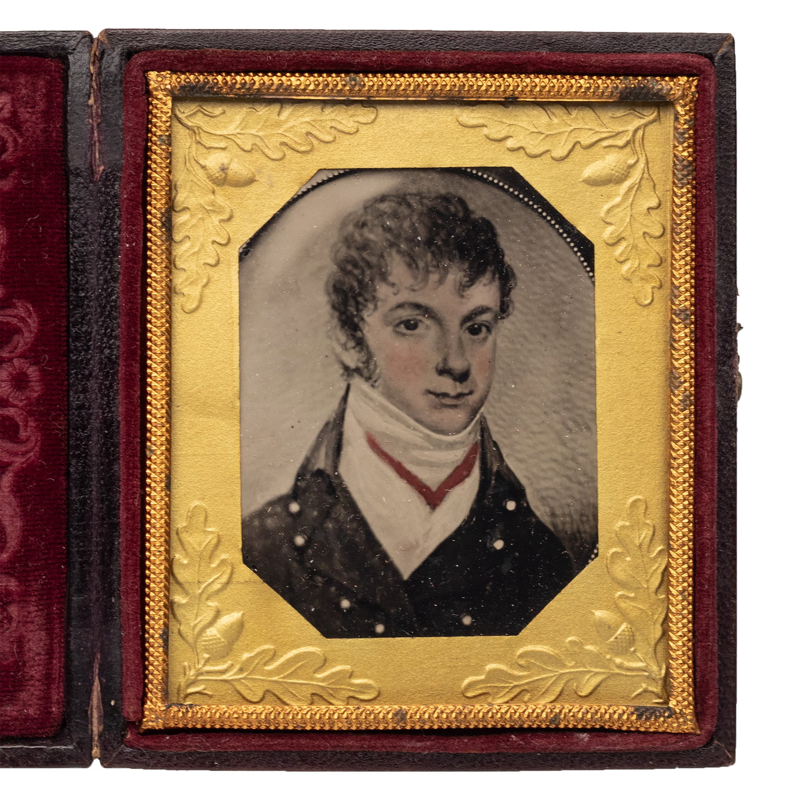 [MILITARIA] Painted Ambrotype of Soldier: Bust-length portrait of a man. Sixth plate painted ambrotype. Oak leaf brass mat, full leatherette case with floral design. An attractive painted ambrotype portrait of a young gentleman