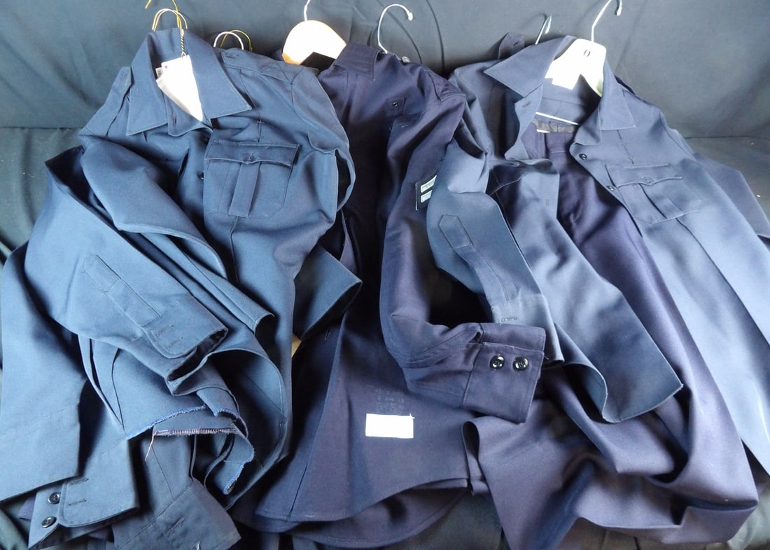 Large lot of Movie Costume Police uniforms and pants: Most Marked with Names and some have Warner Brothers Inventory Tags on them. Roughly 5 single shirts and 5 shirt and pant sets for a total of 15 pieces