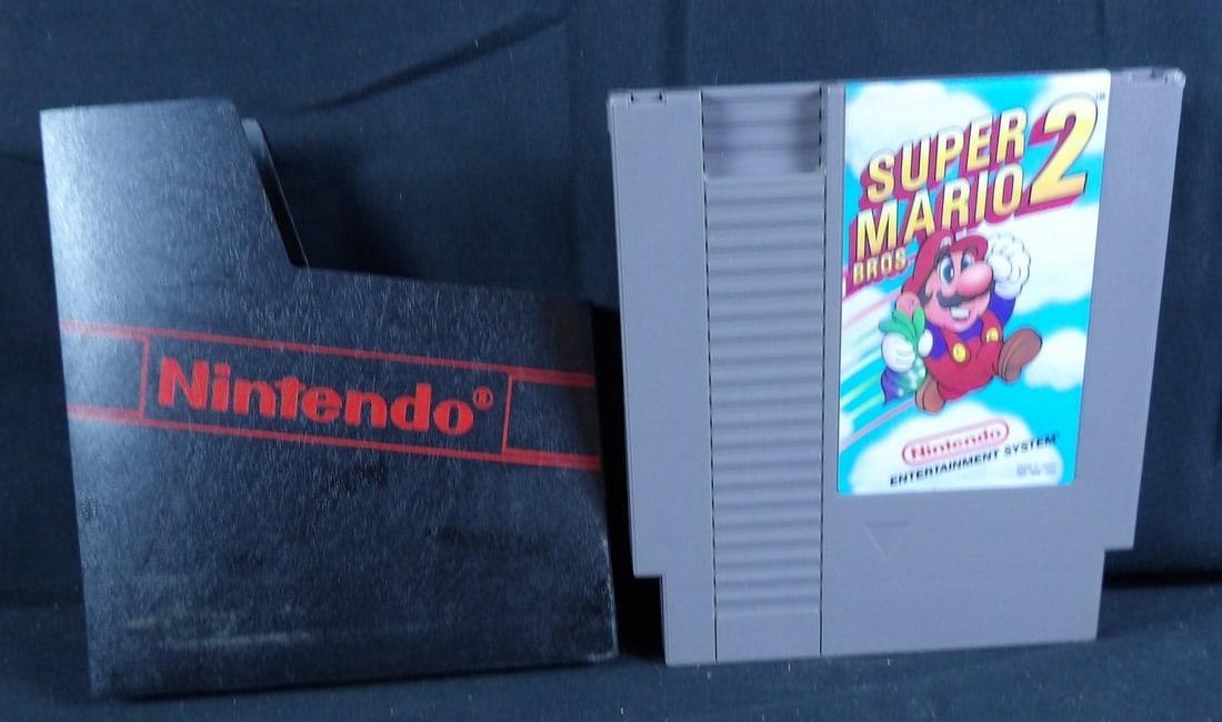 Original NES Super Mario Brothers 2 Game cartrdige and sleeve: Named etched on back of game. Small scrape on top corner. Untested