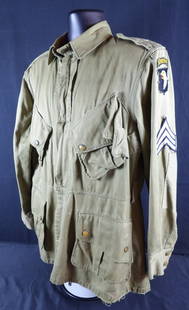 WW2 WWII Airborne Paratrooper 101st M42 Jump Jacket: Laundry Numbered. unique stitching of rank and 101st patch. Field repairs present. Snags and stains also present on jacket. No belt