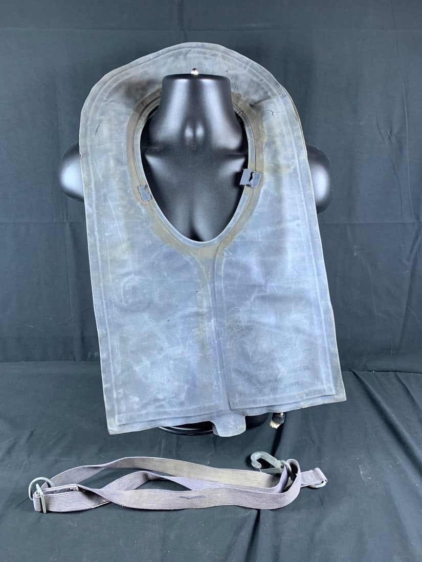 WW2 WWII USN/USMC Mae West Inflatable Life Preserver: Dated 1945. Cracks in neoprene. Strap present but loops are torn. Pliable but stains on Vest