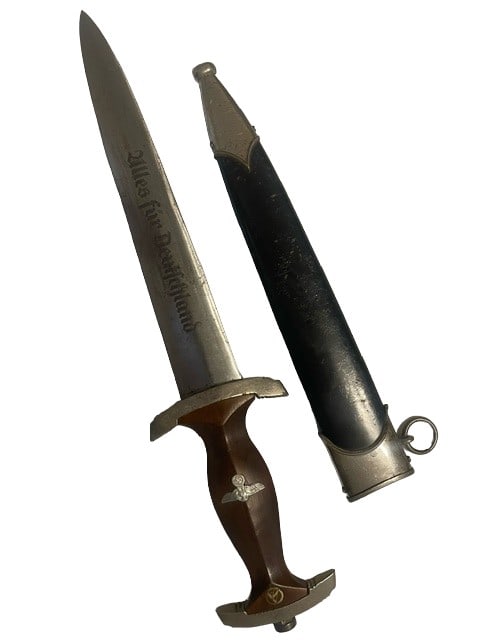 WWII German NSKK Dagger Nazi Motor Corps: The dagger is the classic SA style with “Alles fur Deutschland” marked blade and black painted metal scabbard as worn by the NSKK. The metal scabbard shows bubbling to the paint, but t display