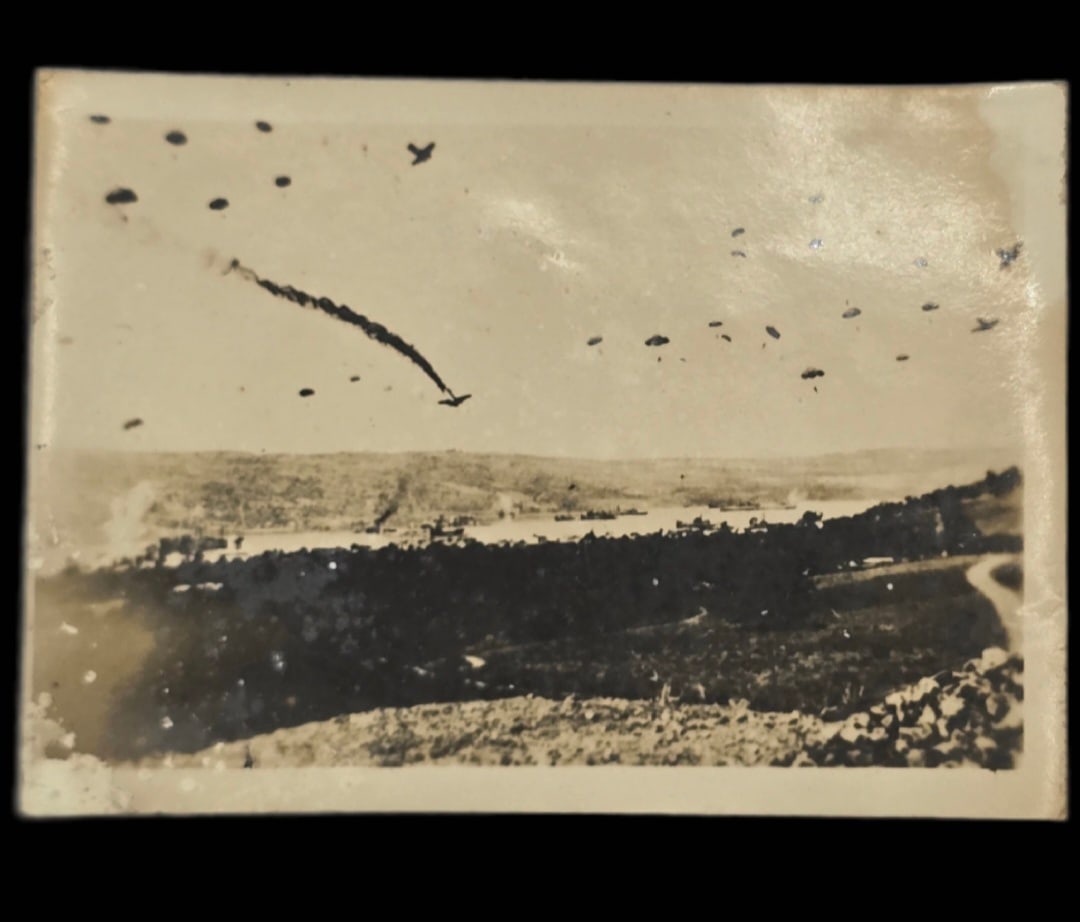 Extremely Rare WWII German Paratrooper jump photo with downed plane: Extremely Rare WWII German Paratrooper jump photo with downed plane.The image depicts the Battle of Crete, a significant event during World War II, specifically showing German paratroopers during Oper