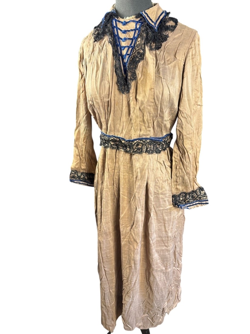 Early 1900s Day Dress: Light brown light-weight day dress with black lace and royal blue velvet trim. Based on the fabric and the bodice front detailing this dress is most likely from about 1915. Offset snap closures are un