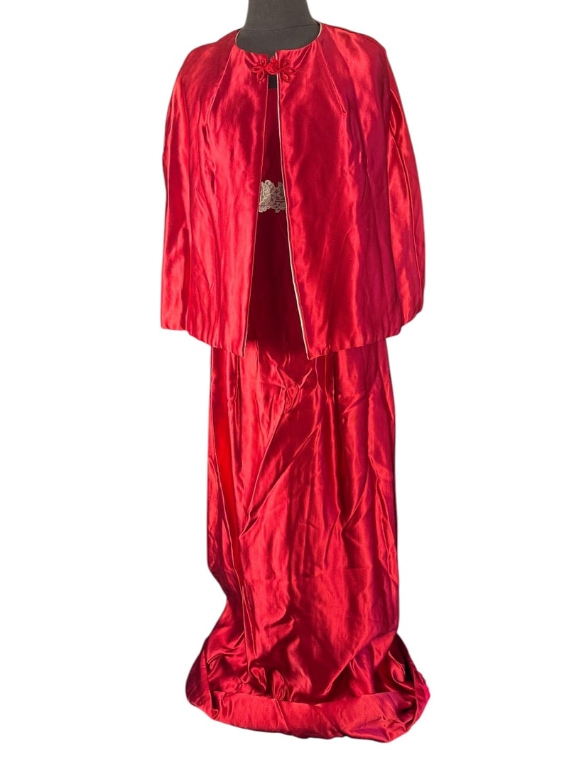1960s Red Satin Christmas Gown and Cape: This red satin Christmas Ball gown with matching cape is made with a heavy satin with a flocked backing. White satin lining and metal zipper