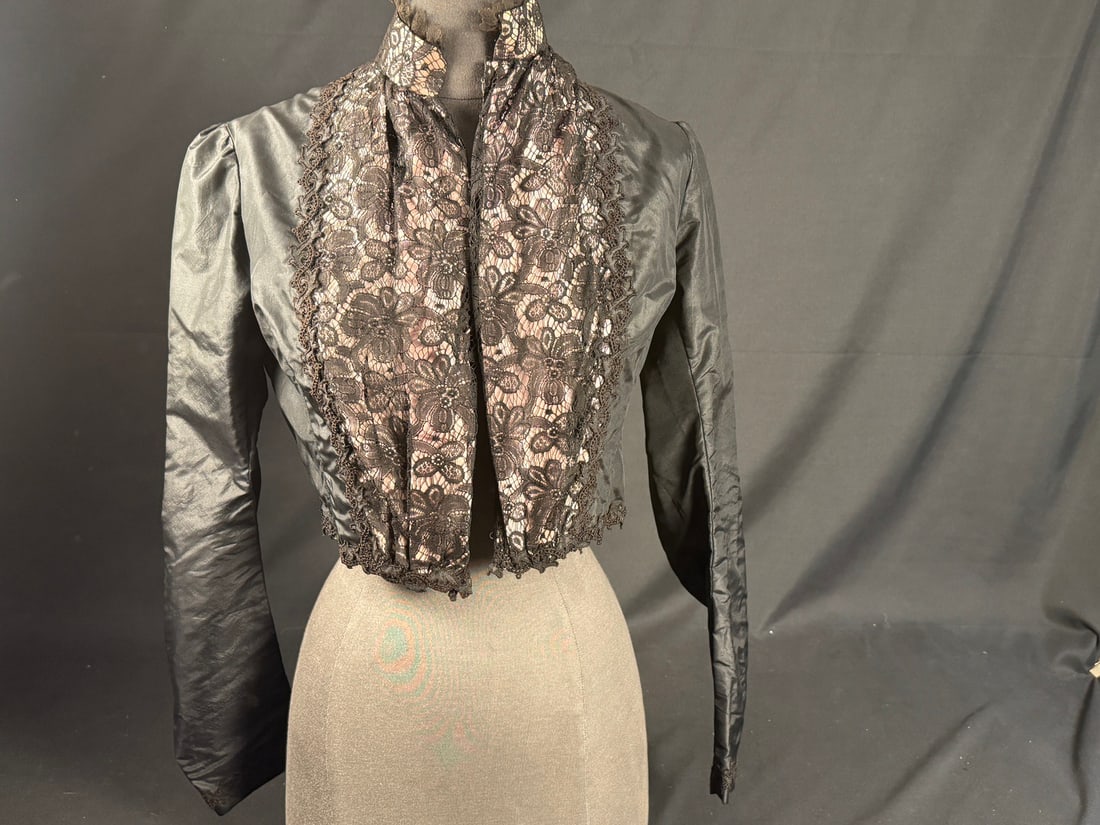 1905 Black Edwardian Bodice: Black silk Edwardian bodice with machine lace front and hook and eye closure. Neckline lace in excellent condition. Light boning in the seam allowances. Exceptional sewing technique and in wearable co