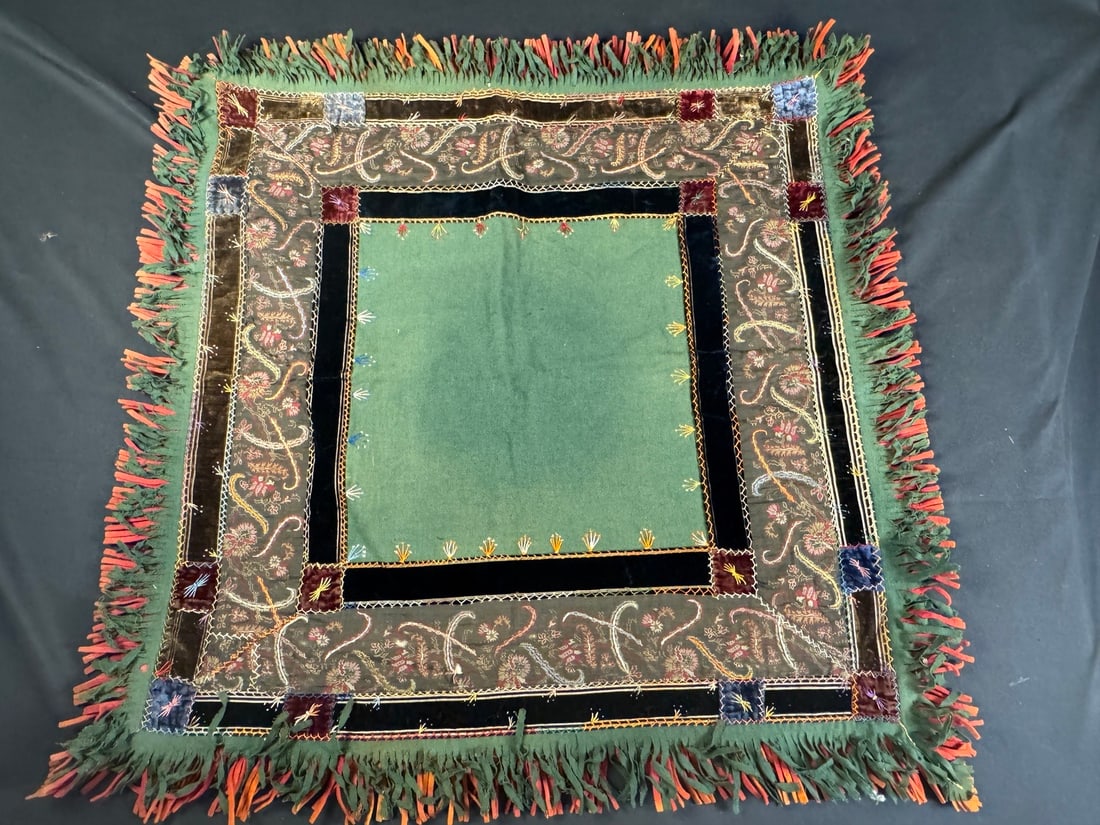 Victorian Carriage Blanket, circa 1880?1910: A finely worked carriage lap robe featuring a central green wool field framed by pieced velvet and floral brocade panels, enhanced with decorative hand embroidery in multiple colors. Embroidered feath