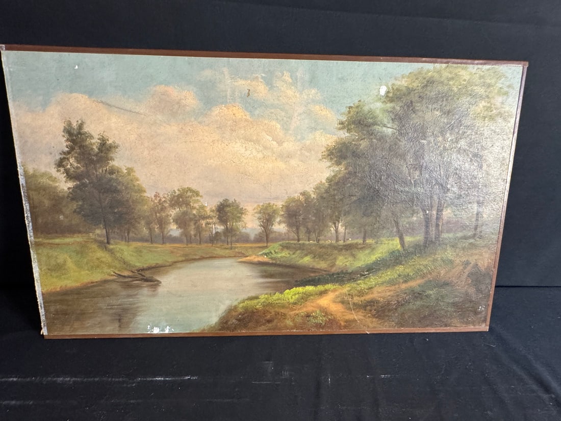 19th Century American School River Landscape - Signed: Oil on canvas depicting a tranquil river bend flanked by grassy banks and trees beneath a luminous sky filled with rolling clouds. The artist captures the gentle play of light across water and foliage