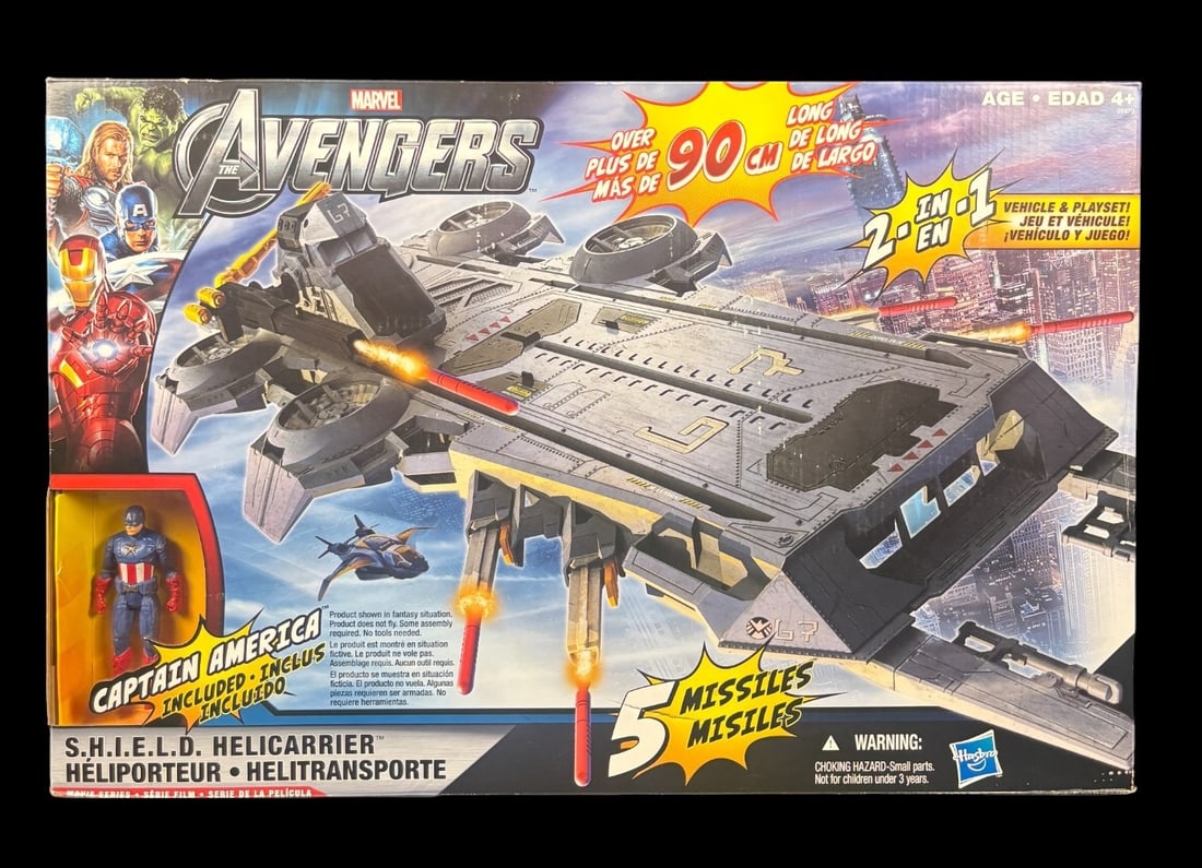 Hasbro Marvel the Avengers S. h. i. e. l. d. Helicarrier & Captain America Figure, New in Box, 2011: A Hasbro Marvel The Avengers S.H.I.E.L.D. Helicarrier playset, released in 2011, presented new in its original cardboard packaging. This modern-period plastic vehicle and playset includes a Captain Am