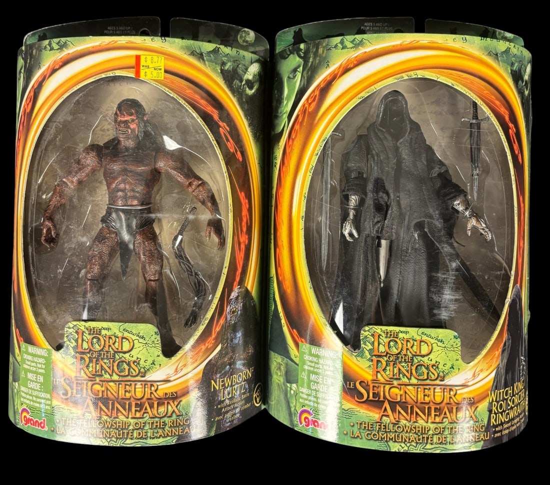 A Pair of Grand the Lord of the Rings: the Fellowship of the Ring Action Figures, Newborn Lurtz and: A pair of action figures from Grand-s -The Lord of the Rings: The Fellowship of the Ring- series, dated 2001. The first figure depicts -NEWBORN LURTZ,- a reddish-brown, muscular character, accessorize